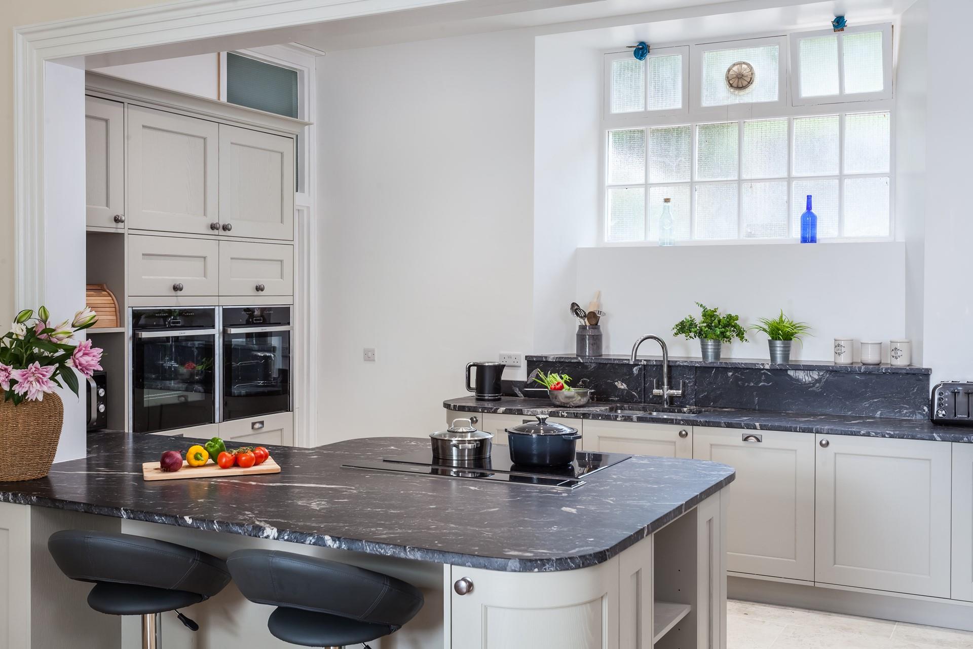 The handcrafted kitchen features marble worktops. Enjoy a morning coffee on one of the bar stools while you cook up a full Cornish breakfast. 