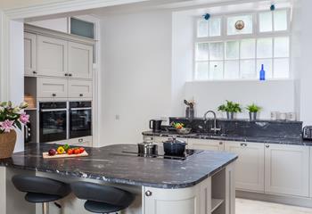 The handcrafted kitchen features marble worktops. Enjoy a morning coffee on one of the bar stools while you cook up a full Cornish breakfast. 