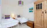 We love the bright and airy twin room in this gorgeous seaside cottage.  - Thumbnail Image