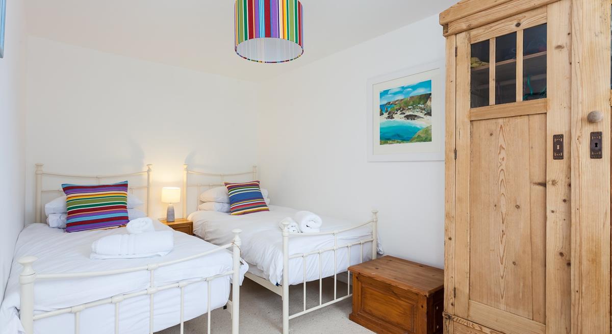 We love the bright and airy twin room in this gorgeous seaside cottage. 