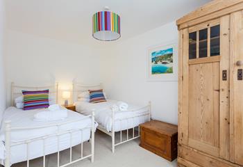 We love the bright and airy twin room in this gorgeous seaside cottage. 