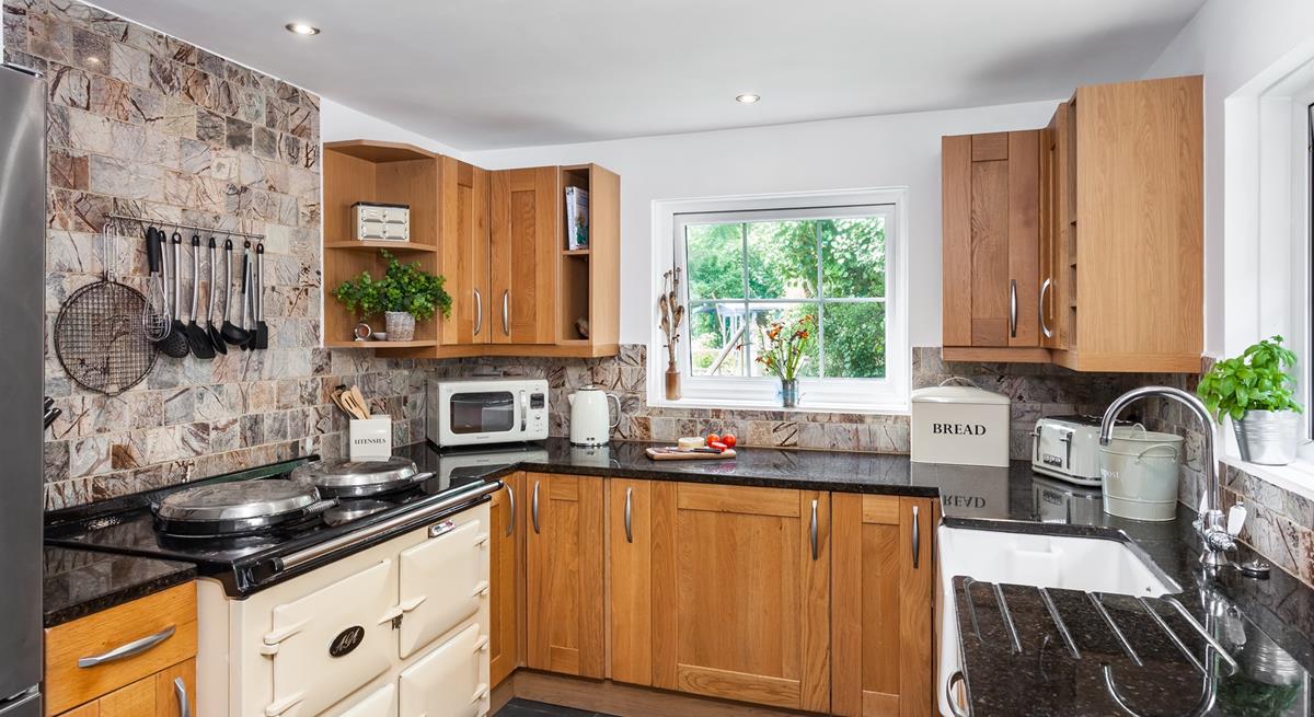 The electric Aga in the spacious kitchen is perfect for cooking a roast lunch or a family feast. 