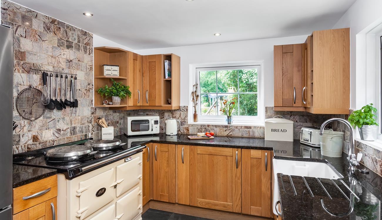 The electric Aga in the spacious kitchen is perfect for cooking a roast lunch or a family feast. 