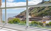 Enjoy breathtaking views from the upstairs sitting room in this reverse-level property.  - Thumbnail Image