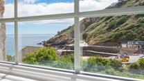 Enjoy breathtaking views from the upstairs sitting room in this reverse-level property. 
