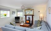 The comfortable furnishings and cosy woodburner provide the perfect environment in which to relax. - Thumbnail Image