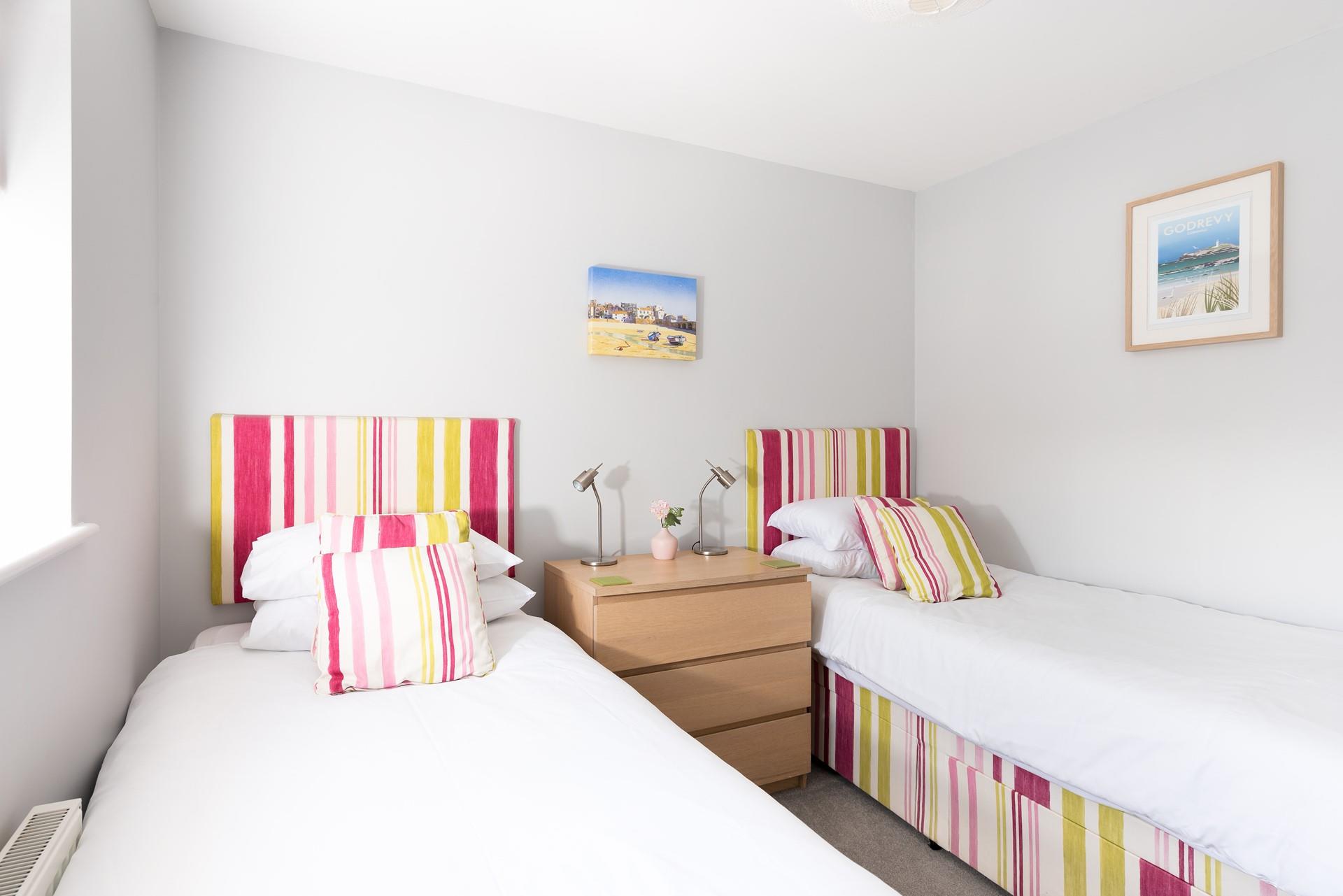 The bright twin room is perfect for settling the kids into bed after a long day.