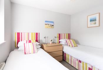 The bright twin room is perfect for settling the kids into bed after a long day.