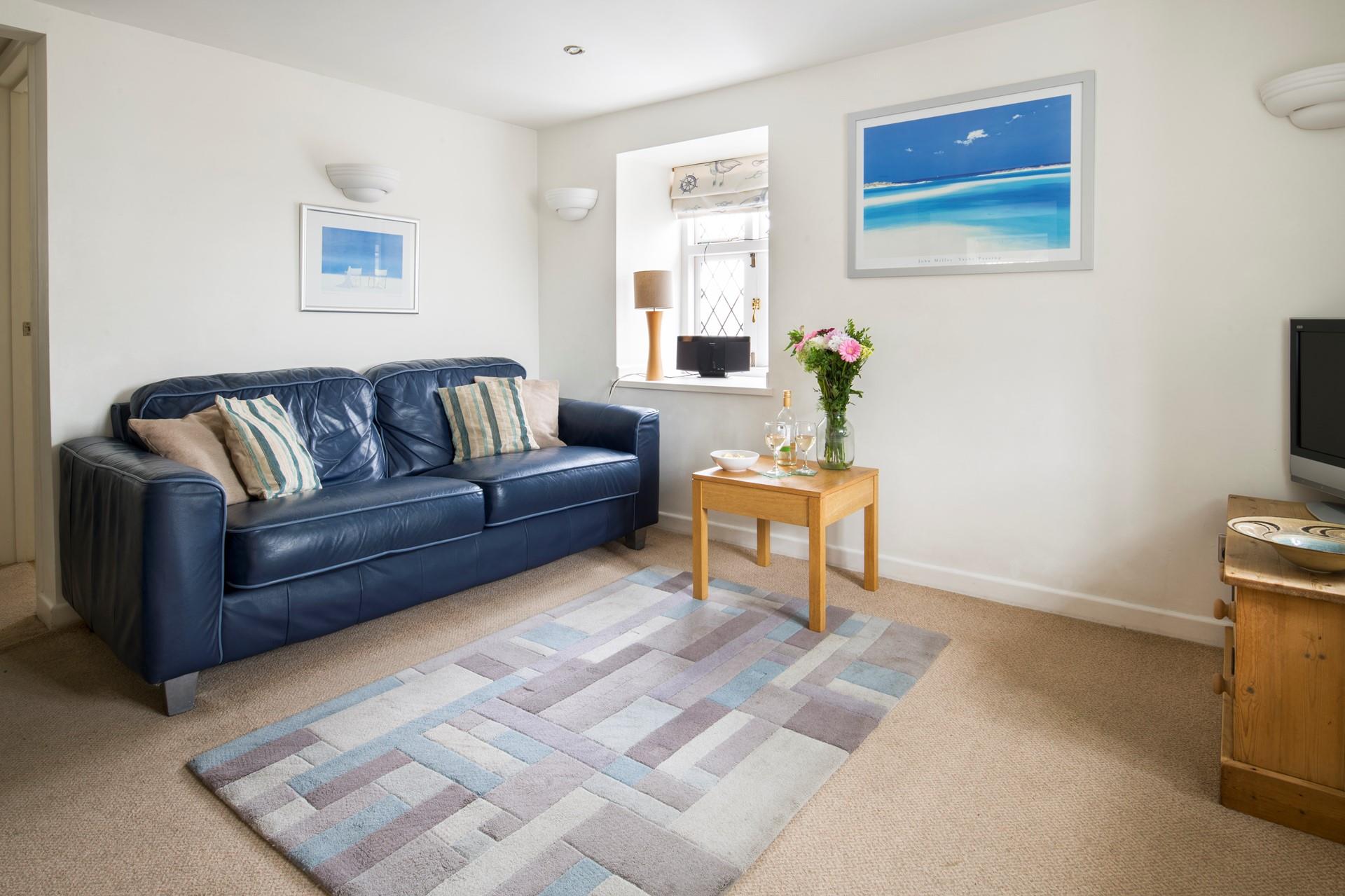 Settle onto the sofa for a cosy evening unwinding with a glass of wine.