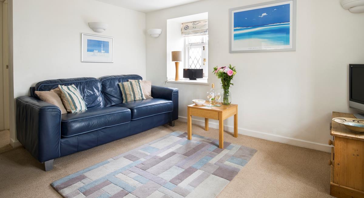 Settle onto the sofa for a cosy evening unwinding with a glass of wine.