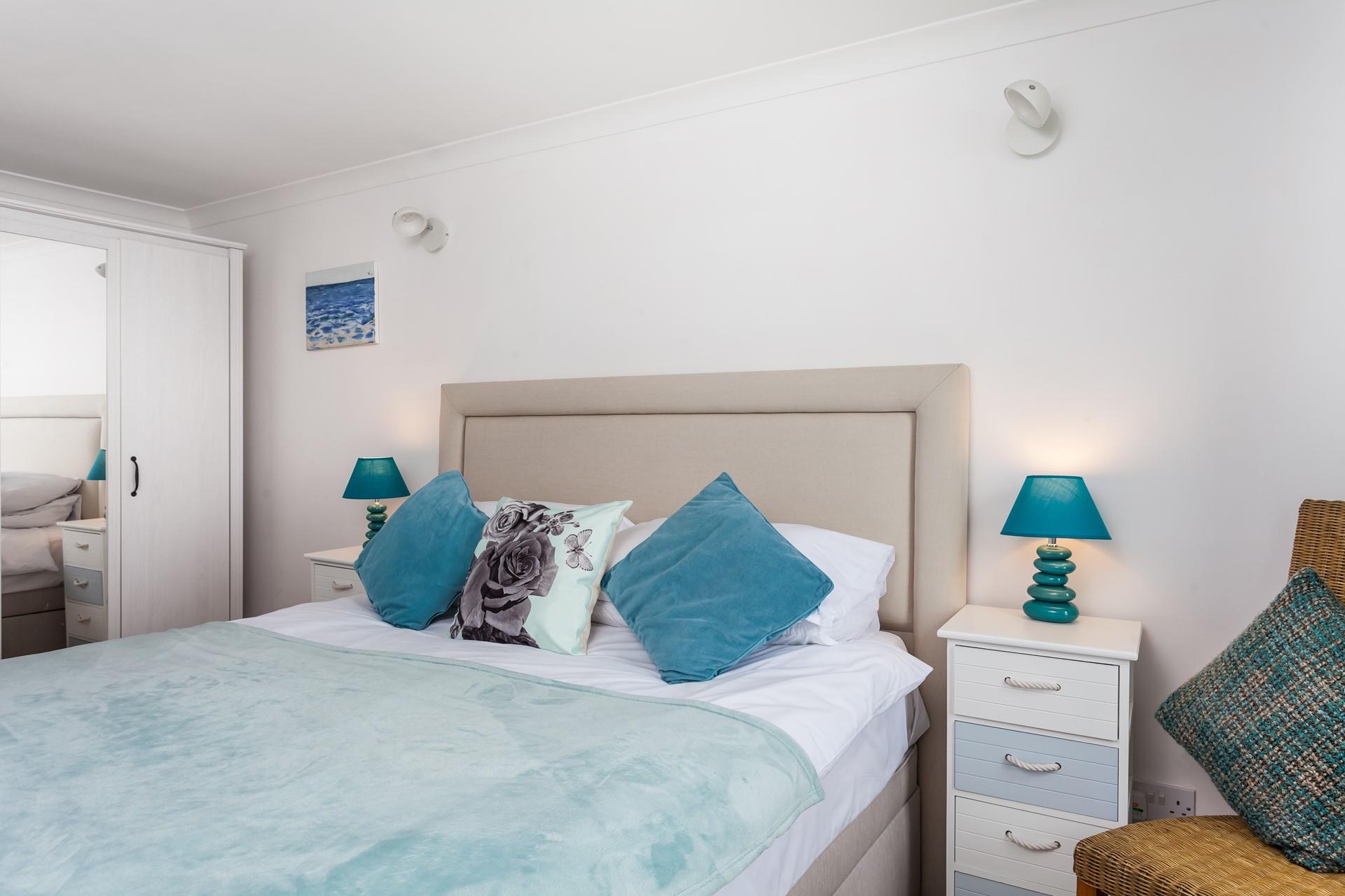 Bedroom 2 is decorated in blues and whites the colours of the sea, reflecting the location.