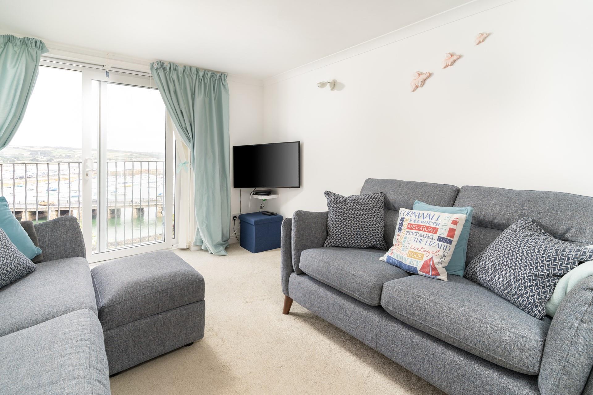 Sink into the plush grey sofa and relax with a glass of wine in the evening.