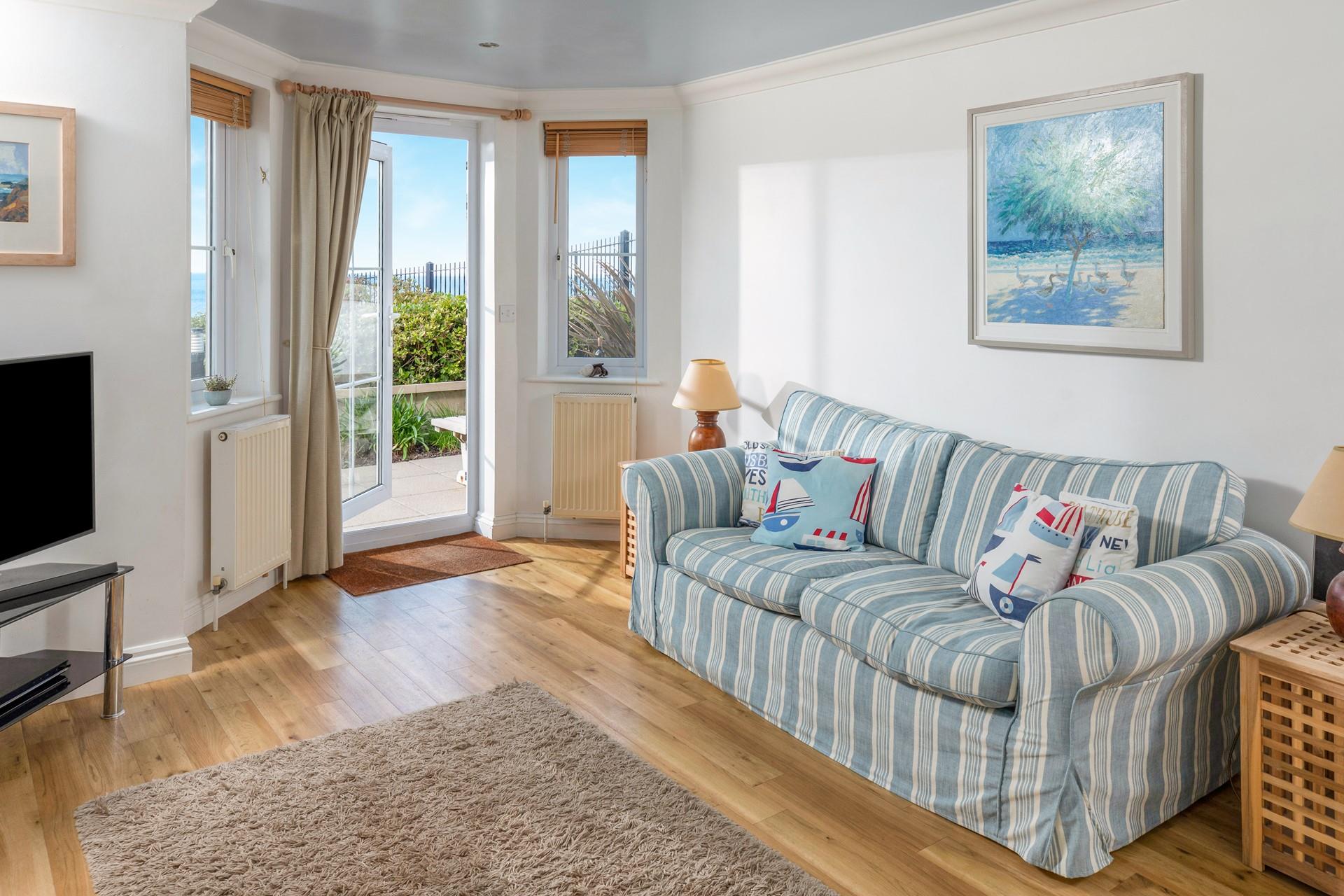 Sink into one of the comfy sofas and watch some TV, or simply enjoy the wonderful sea views. 