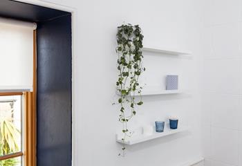 The light and airy bathroom has been decorated with calming sea-themed colours. 