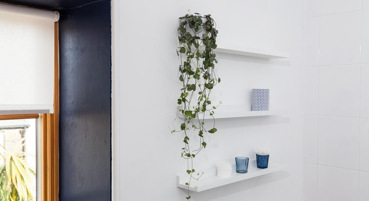 The light and airy bathroom has been decorated with calming sea-themed colours. 