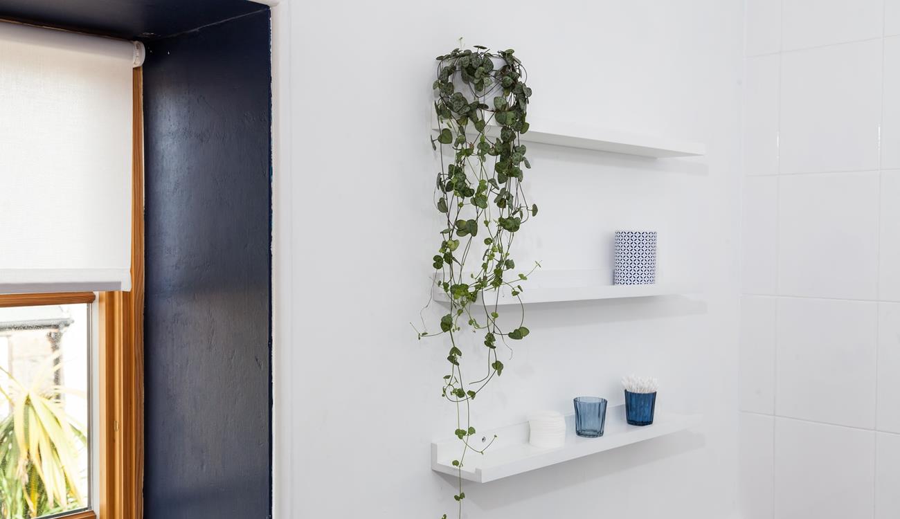 The light and airy bathroom has been decorated with calming sea-themed colours. 