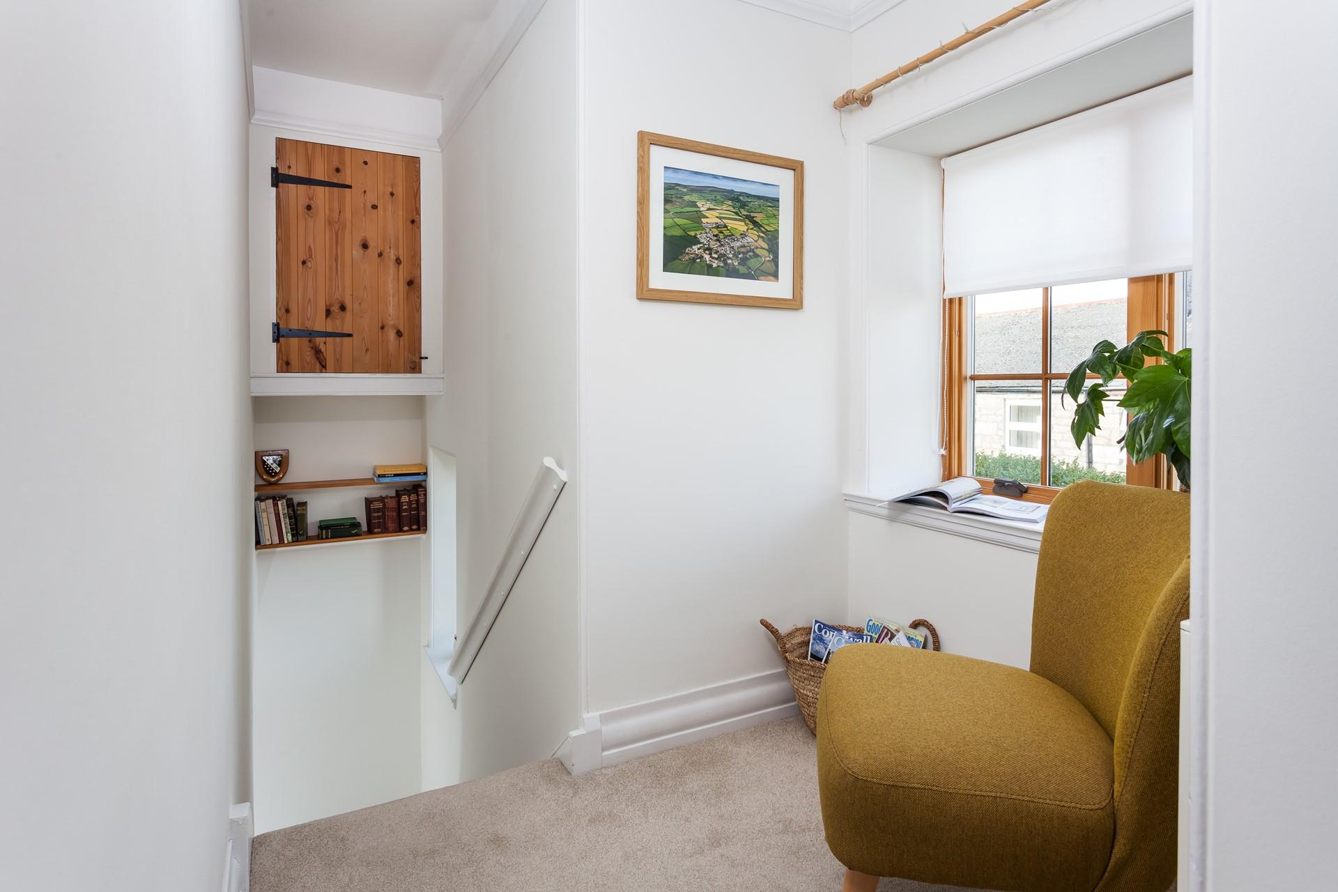 Lose yourself in a good book on the reading chair on the landing.