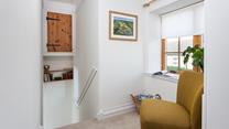 Lose yourself in a good book on the reading chair on the landing.