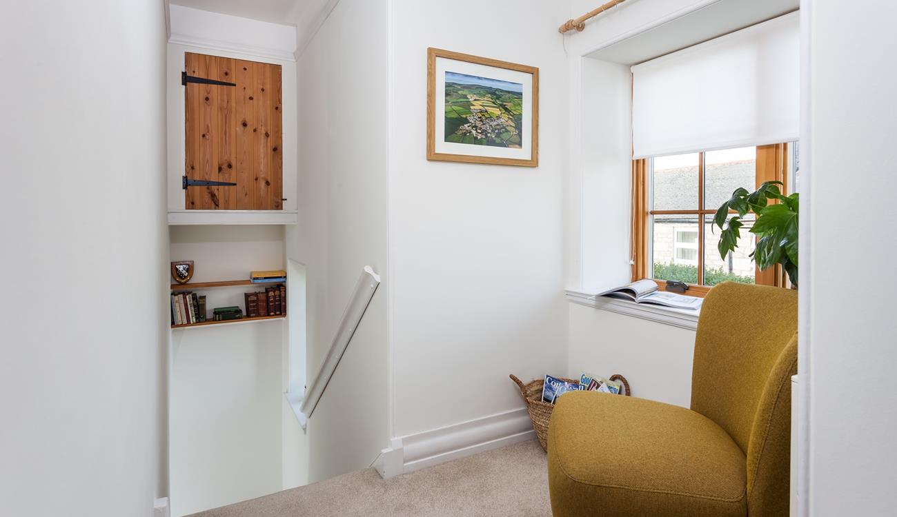 Lose yourself in a good book on the reading chair on the landing.