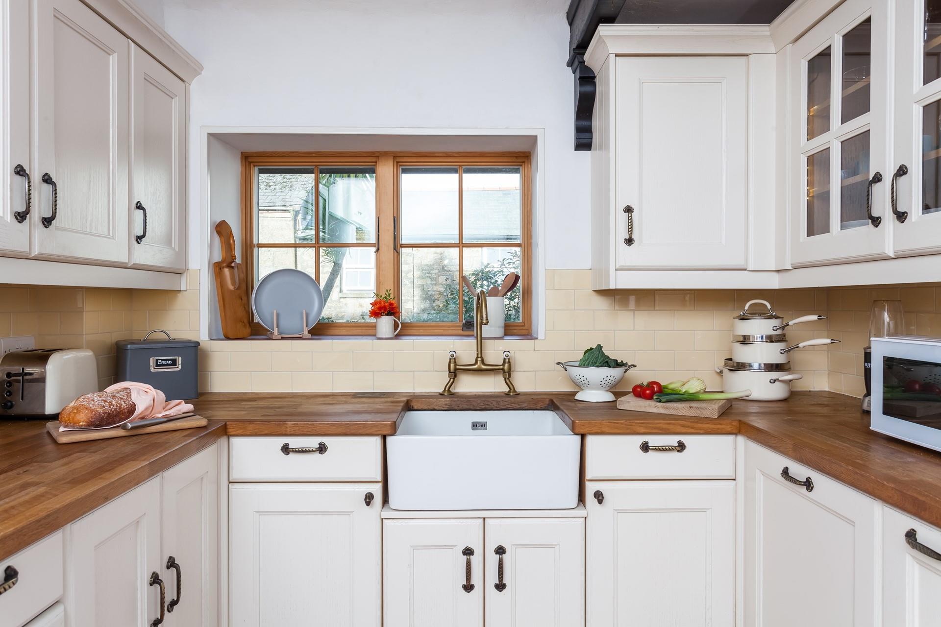 The light and airy kitchen has plenty of storage and all the comforts of home. 