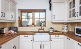 The light and airy kitchen has plenty of storage and all the comforts of home.  - Thumbnail Image