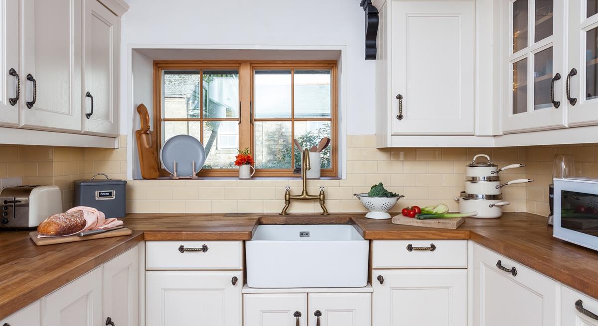 The light and airy kitchen has plenty of storage and all the comforts of home. 