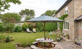 The rear garden at Folnamodry has a large apple tree and plenty of outside space to relax and enjoy a drink. - Thumbnail Image