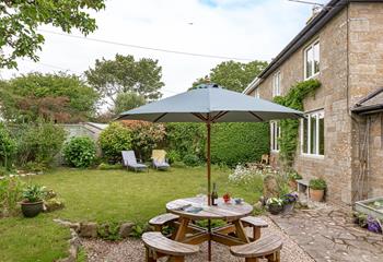 The rear garden at Folnamodry has a large apple tree and plenty of outside space to relax and enjoy a drink.