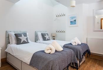 This cosy twin room can be transformed into a king size with these handy zip and link beds, and also benefits from an en suite shower room. 