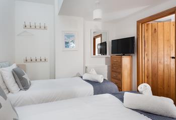 The cosy twin room has plenty of storage and hanging space for your beach clothes and evening wear, plus an en-suite shower room. 