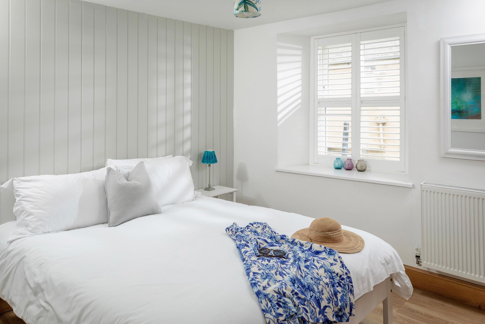 The master bedroom has a luxurious en suite with a double walk-in shower, WC and basin, as well as a comfy king size bed. 