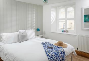 The master bedroom has a luxurious en suite with a double walk-in shower, WC and basin, as well as a comfy king size bed. 