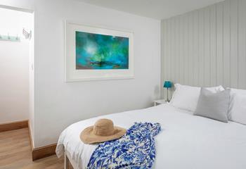 Calming hues and simple decor ensure a relaxing night's sleep.