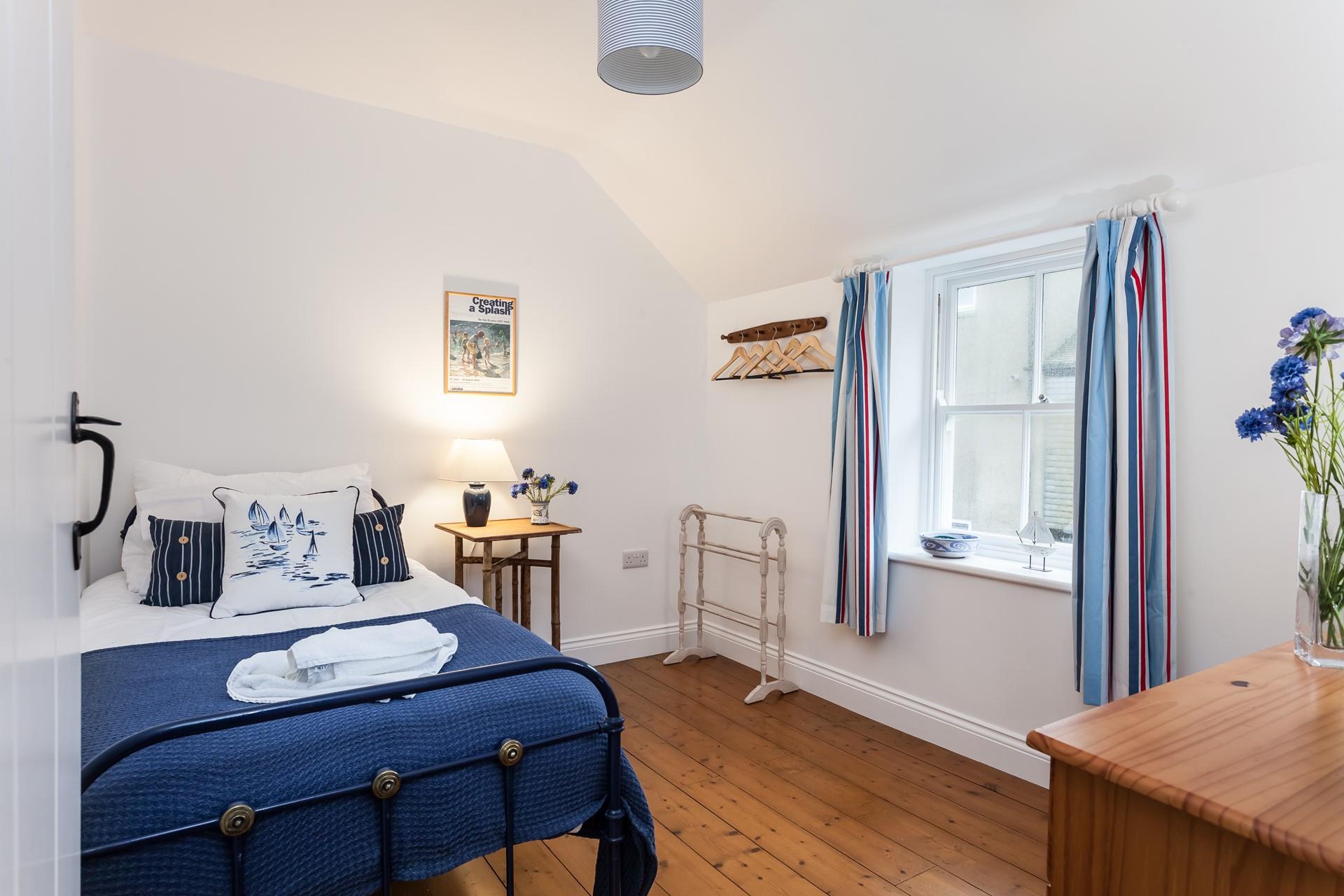 Bedroom 2 has a single bed perfect for young adults or children.