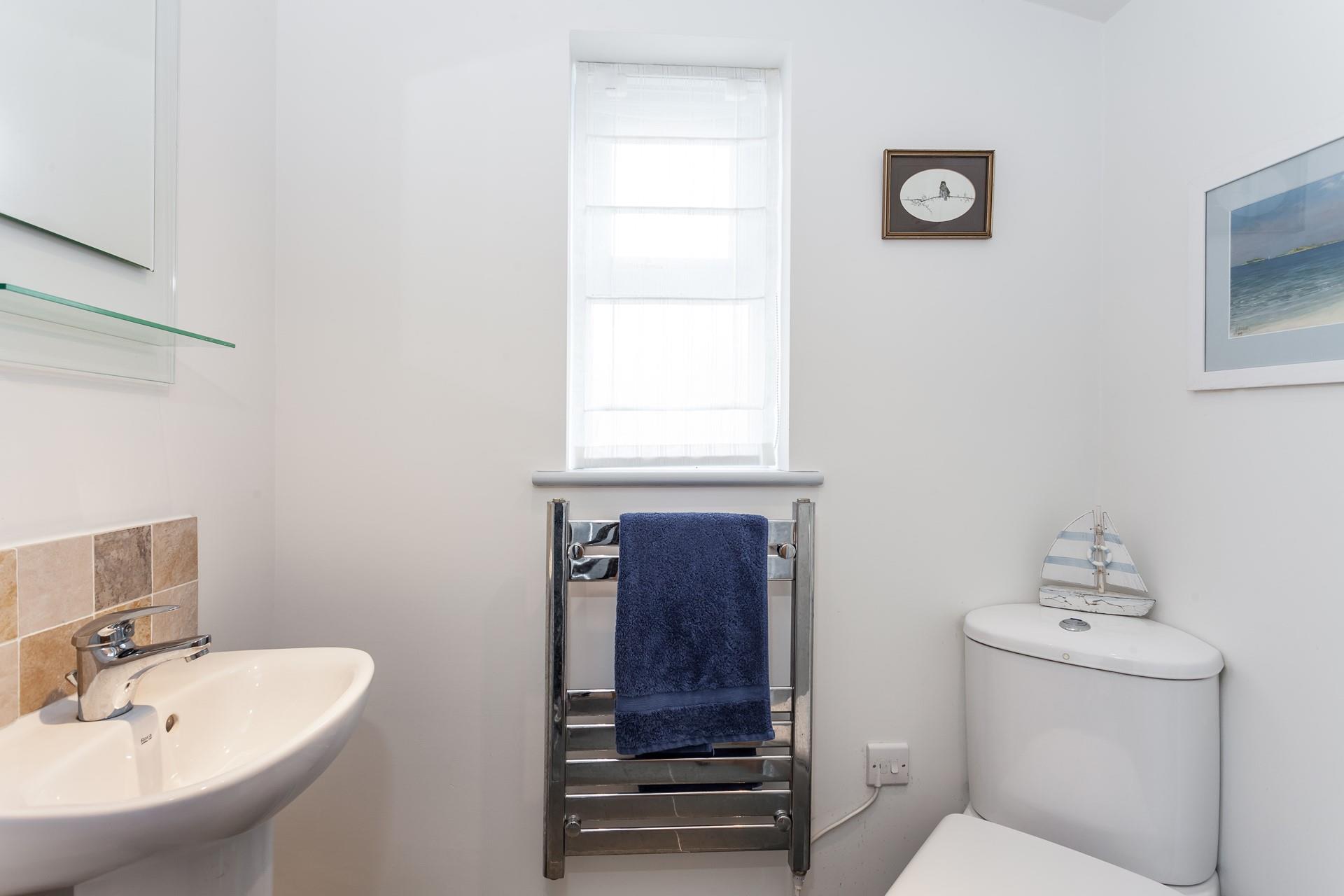 The handy downstairs cloakroom has a WC and basin.