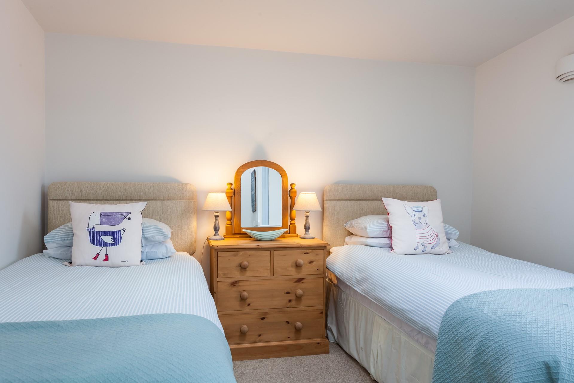 The beautiful twin room has two comfy single beds and a cot, ideal for families. 