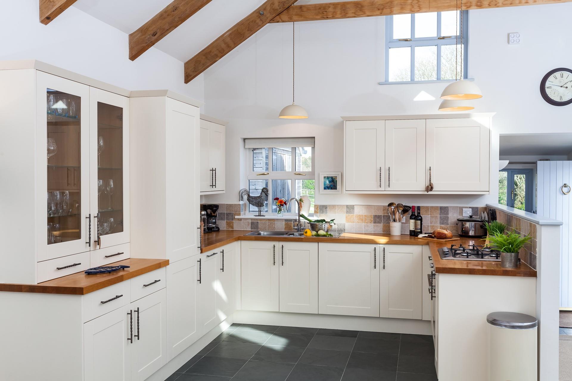 The kitchen blends country chic with modern appliances making it an absolute dream to cook in.