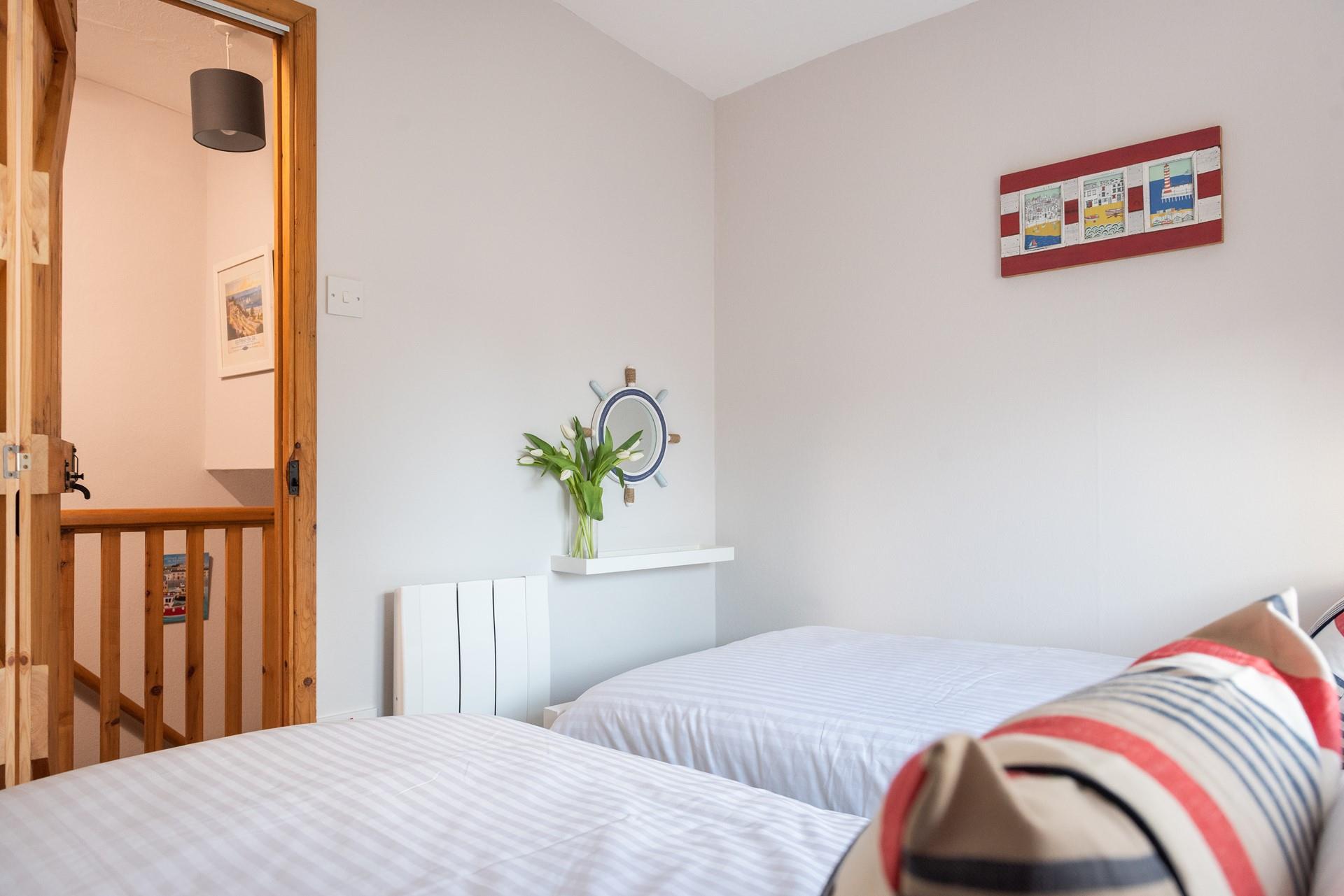 Nautical decor adds a coastal feel to the second bedroom. 