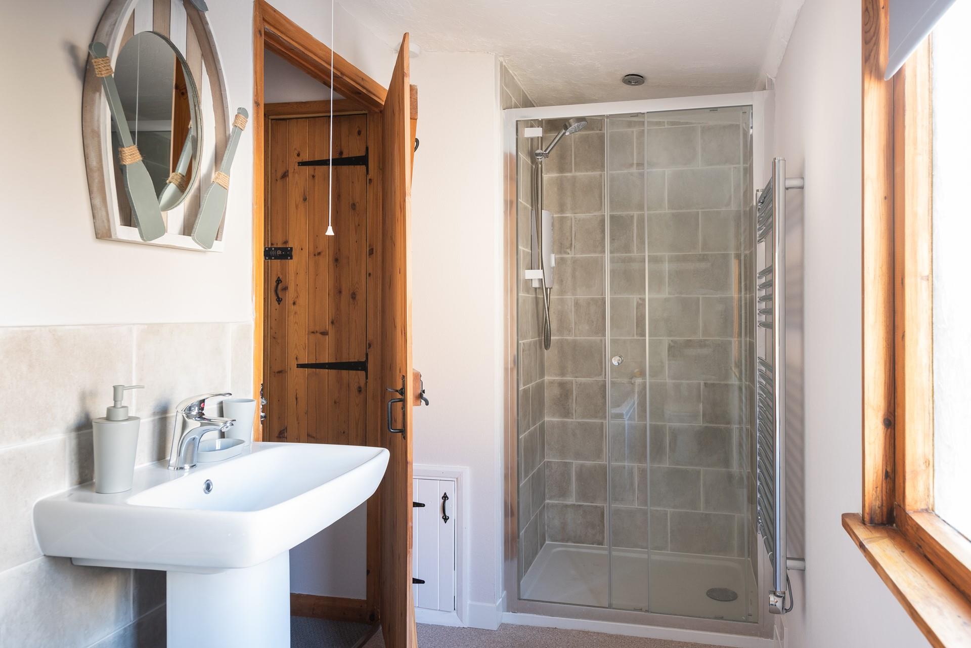 The extra shower in the bathroom is the perfect place to wash away the sand at the end of the day.