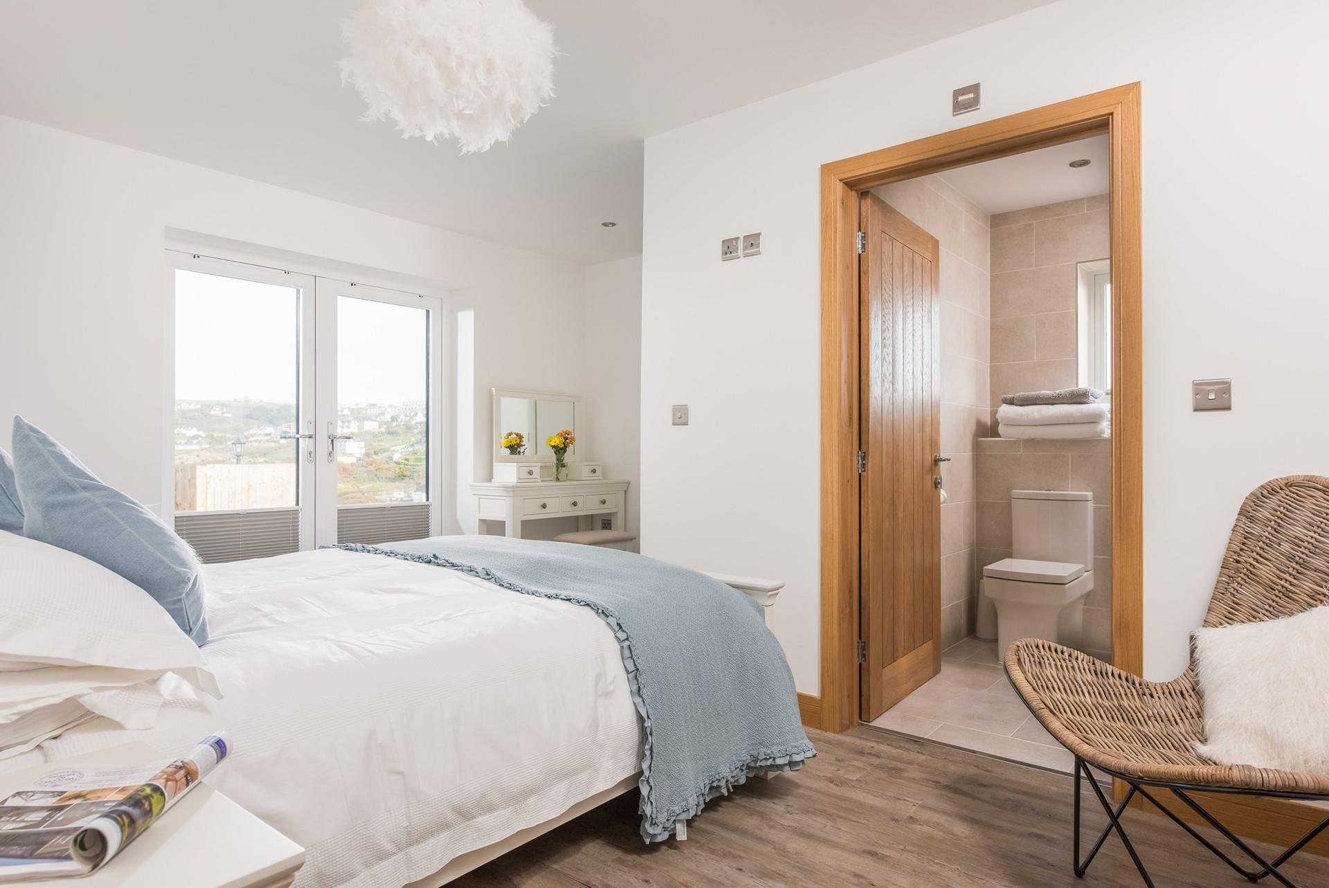 Wake up to the gentle roll of the waves in bedroom 1, with stunning sea views.