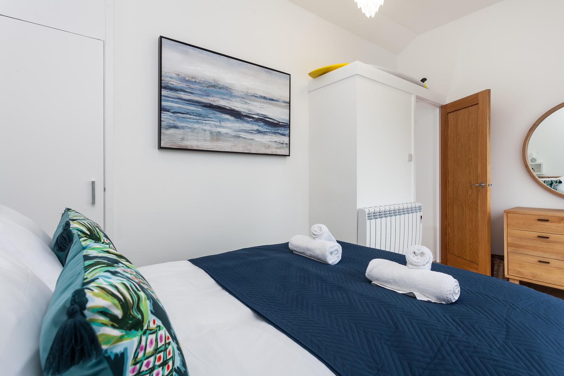 Fluffy towels and soft sheets await in bedroom 2.