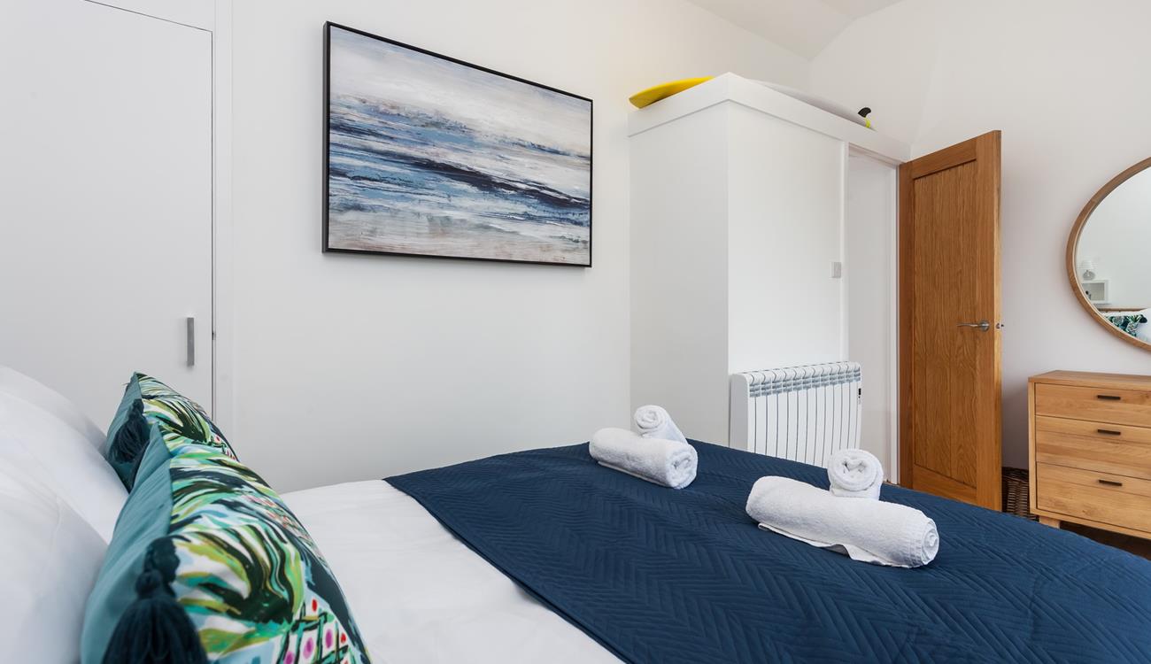 Fluffy towels and soft sheets await in bedroom 2.