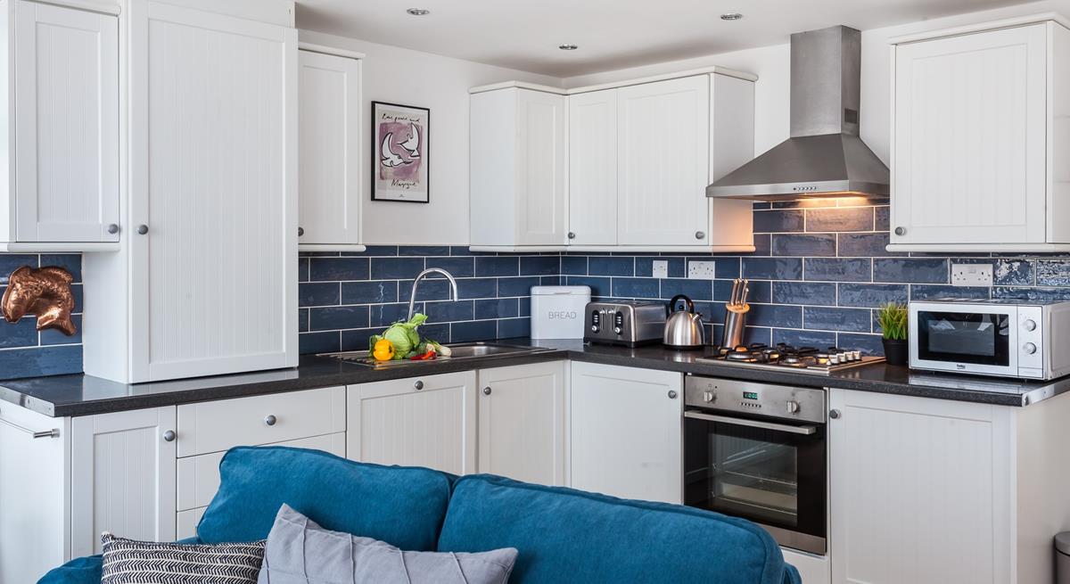 The open plan kitchen has all you need to rustle up a romantic meal for two, whilst enjoying the pretty harbour views. 