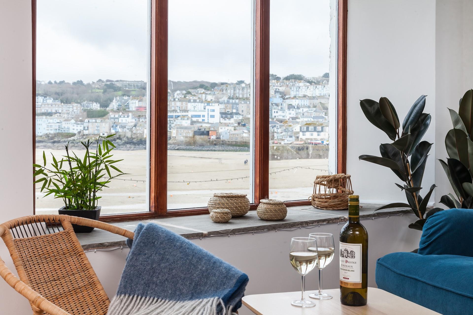 Enjoy unrivalled views across St Ives harbour during your romantic getaway, from the comfy sofa and chairs in the living room. 