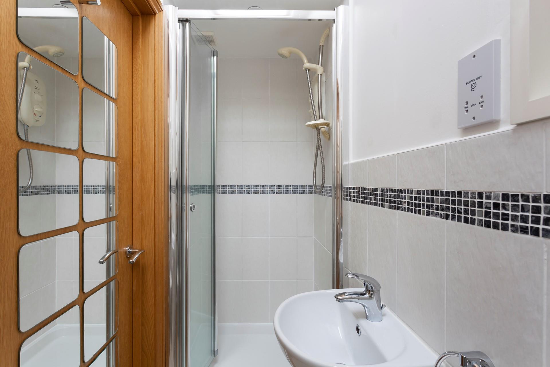 The convenient en suite shower room features a walk-in shower. 