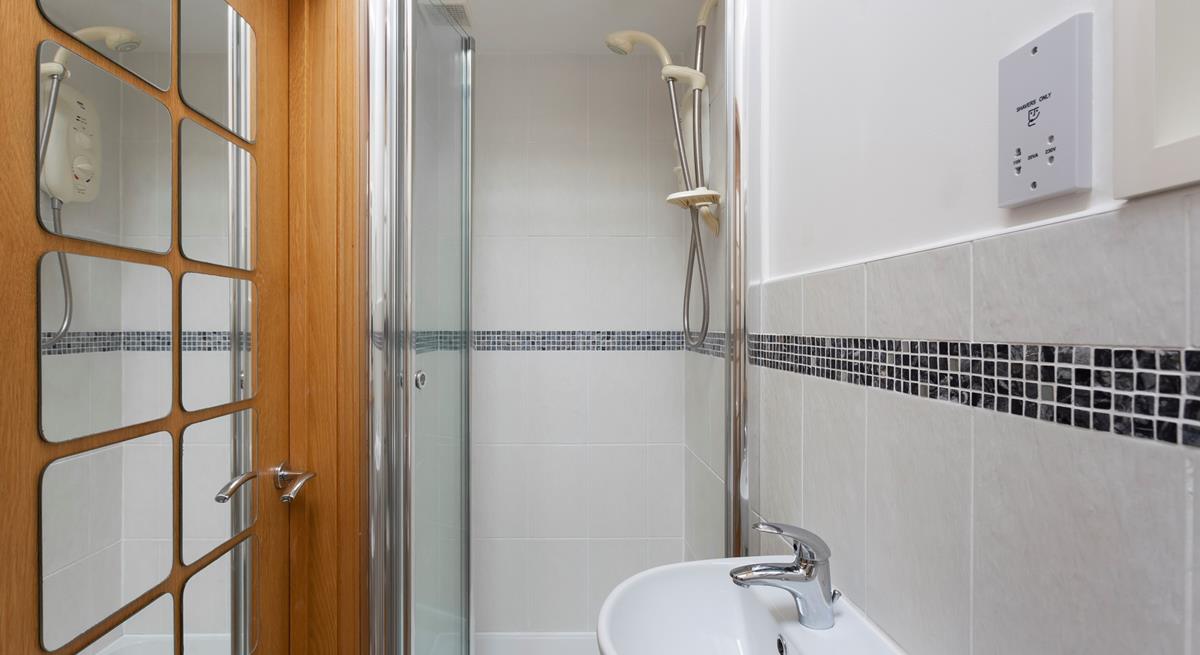 The convenient en suite shower room features a walk-in shower. 
