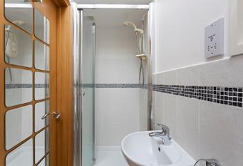 The convenient en suite shower room features a walk-in shower. 