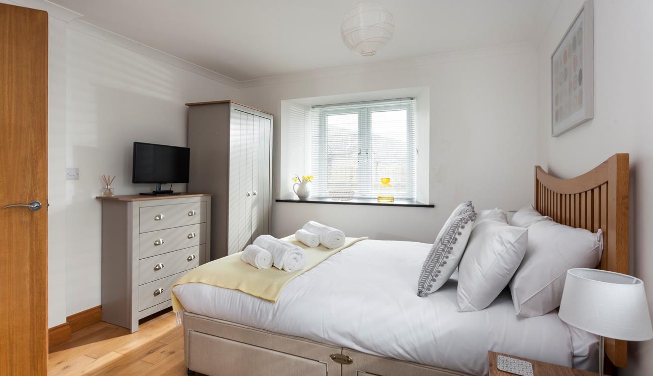Light and spacious, bedroom 1 has plenty of room to unpack and make yourself at home. 