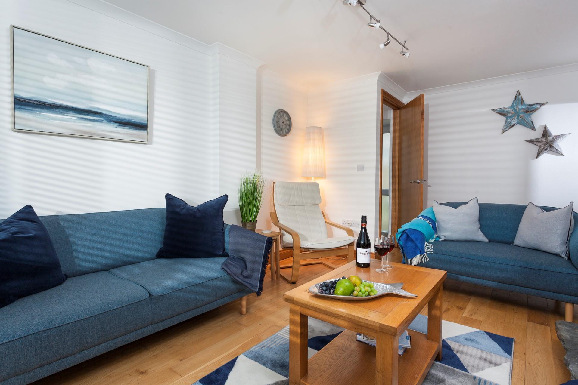 Blue hues and coastal decor encourage a calm and relaxing atmosphere in the sitting room. 