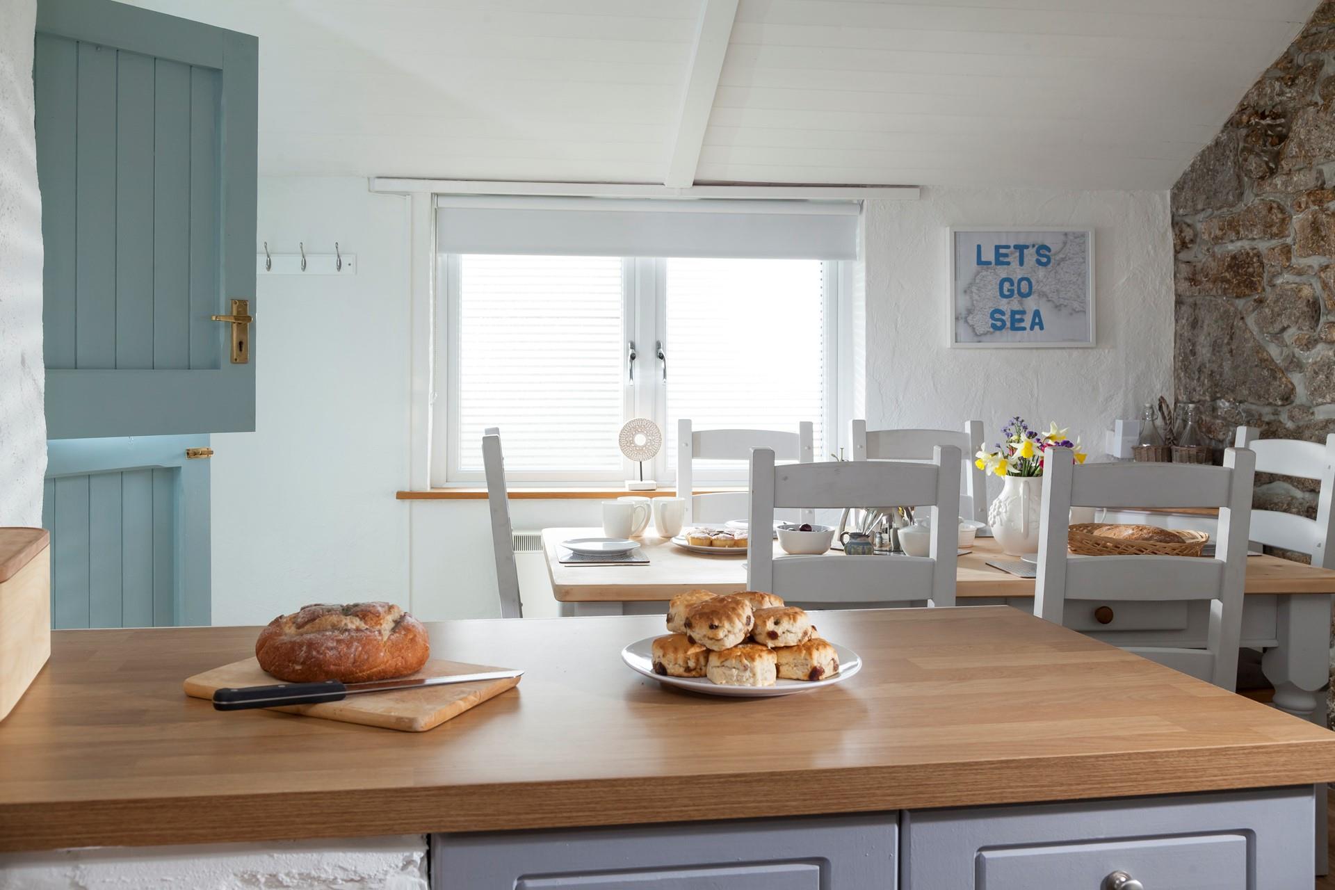 With its stable door, exposed granite wall, farmhouse-style table and slanted roof, the dining room exudes character and charm.